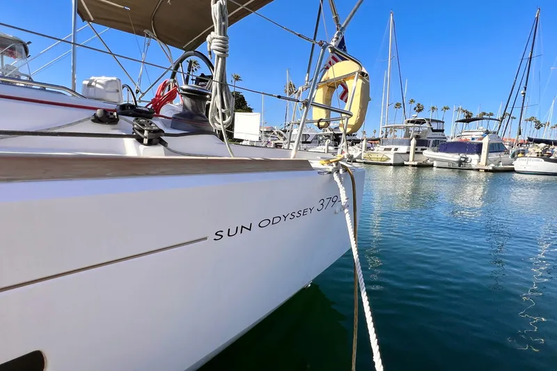 Slide: The Image of 2015 Jeanneau Sun Odyssey 379 sailboat docked in a marina under clear blue skies. - 8