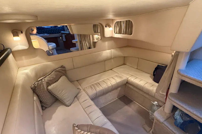 Slide: The Image of Luxurious interior of 2001 Sea Ray 340 Sundancer yacht with cozy seating and ambient lighting. - 30