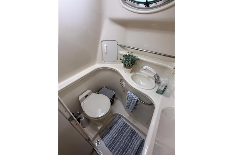 Slide: The Image of Bathroom interior of 2001 Sea Ray 340 Sundancer yacht, featuring sink and toilet. - 31
