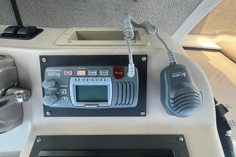 Slide: The Image of Control panel of a 2001 Sea Ray 340 Sundancer boat with Cobra Marine radio. - 14