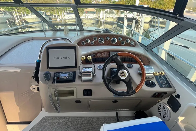 Slide: The Image of Cockpit of 2001 Sea Ray 340 Sundancer with Garmin navigation system and classic steering wheel. - 11