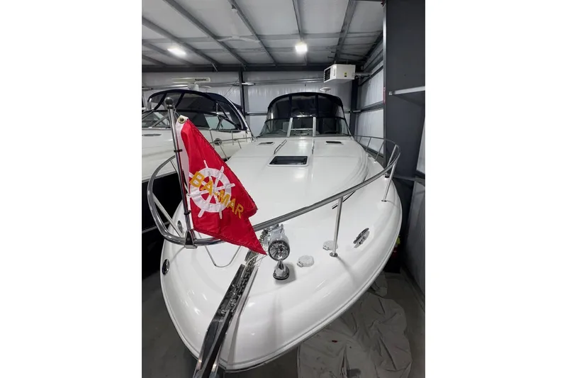 Slide: The Image of 2001 Sea Ray 340 Sundancer yacht in storage, featuring a red flag on the bow. - 6