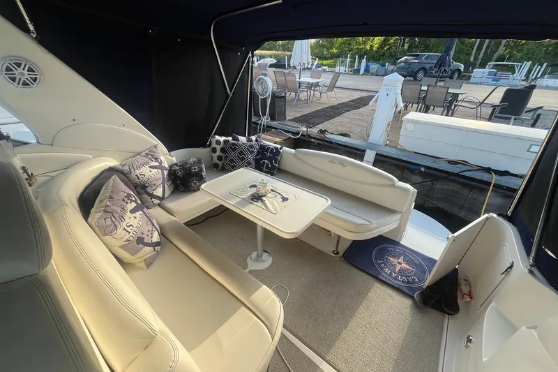 Slide: The Image of Interior of 2001 Sea Ray 340 Sundancer yacht with seating and nautical-themed decor. - 7