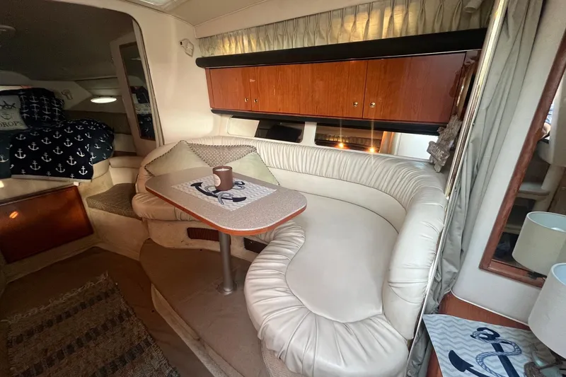 Slide: The Image of Interior of 2001 Sea Ray 340 Sundancer with cozy seating and nautical decor. - 20