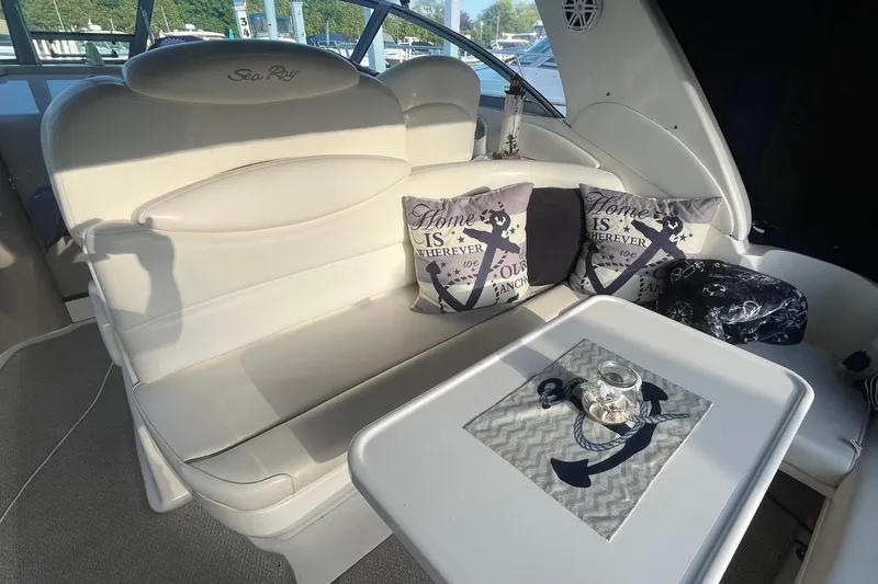 Slide: The Image of Interior of 2001 Sea Ray 340 Sundancer with cushioned seating and nautical-themed decor. - 8