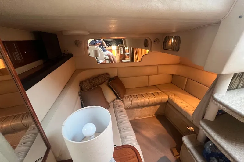 Slide: The Image of Interior of 2001 Sea Ray 340 Sundancer yacht with cozy seating and ambient lighting. - 23