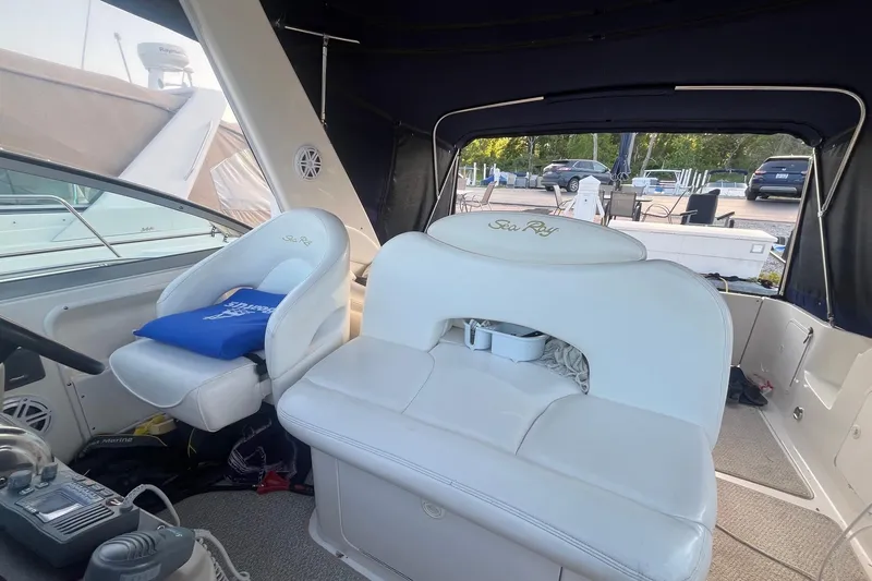 Slide: The Image of 2001 Sea Ray 340 Sundancer cockpit with white seating and helm station. - 10