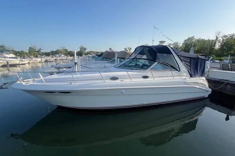 Slide: The Image of 2001 Sea Ray 340 Sundancer yacht docked in a marina under clear blue sky. - 1
