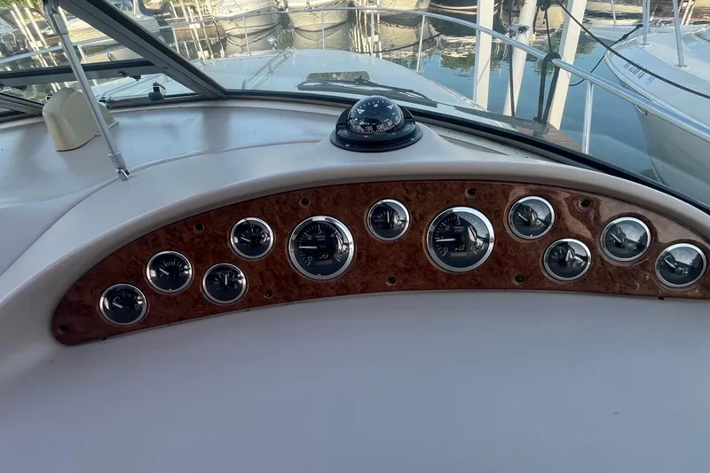 Slide: The Image of Dashboard of a 2001 Sea Ray 340 Sundancer boat with gauges and compass. - 12