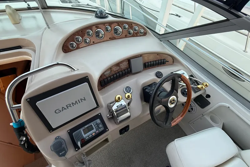 Slide: The Image of Helm of 2001 Sea Ray 340 Sundancer with Garmin navigation system and classic wood accents. - 16