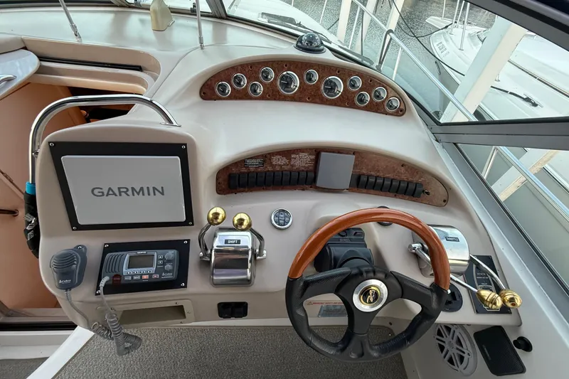 Slide: The Image of Helm of 2001 Sea Ray 340 Sundancer with Garmin navigation and wood-accented steering wheel. - 15