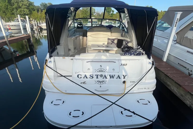 Slide: The Image of 2001 Sea Ray 340 Sundancer docked, featuring "Castaway" name on the stern. - 4