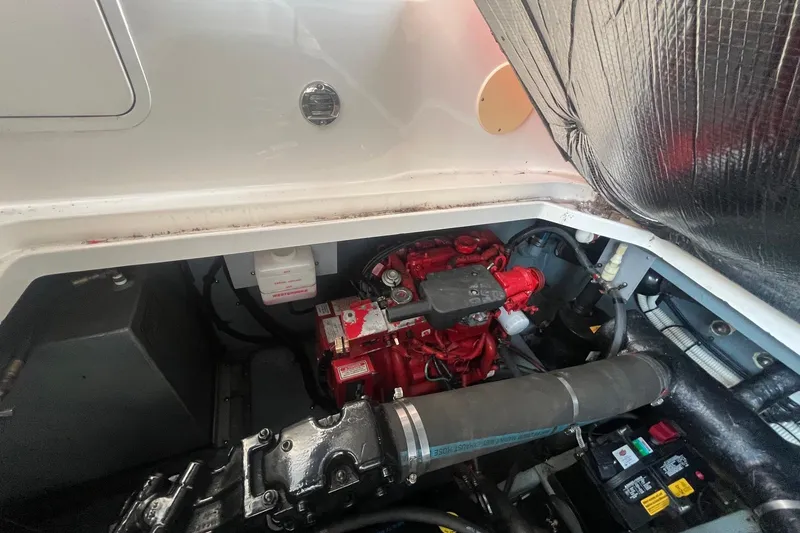 Slide: The Image of Engine compartment of a 2001 Sea Ray 340 Sundancer boat, showcasing mechanical components. - 33