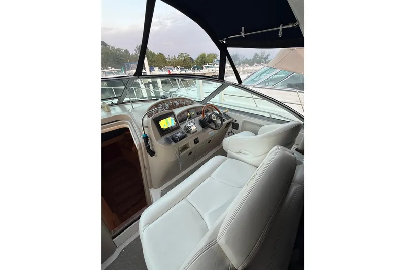 Slide: The Image of Interior view of 2001 Sea Ray 340 Sundancer boat cockpit with steering wheel and navigation system. - 14