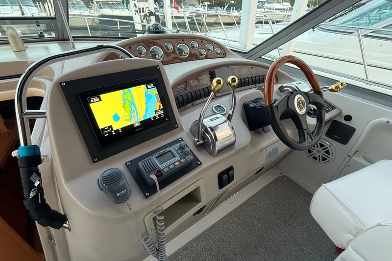 Slide: The Image of Cockpit of 2001 Sea Ray 340 Sundancer with navigation system and controls. - 17