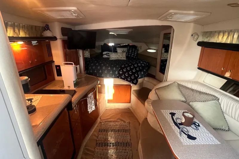 Slide: The Image of Interior of 2001 Sea Ray 340 Sundancer yacht with cozy seating and kitchenette. - 19