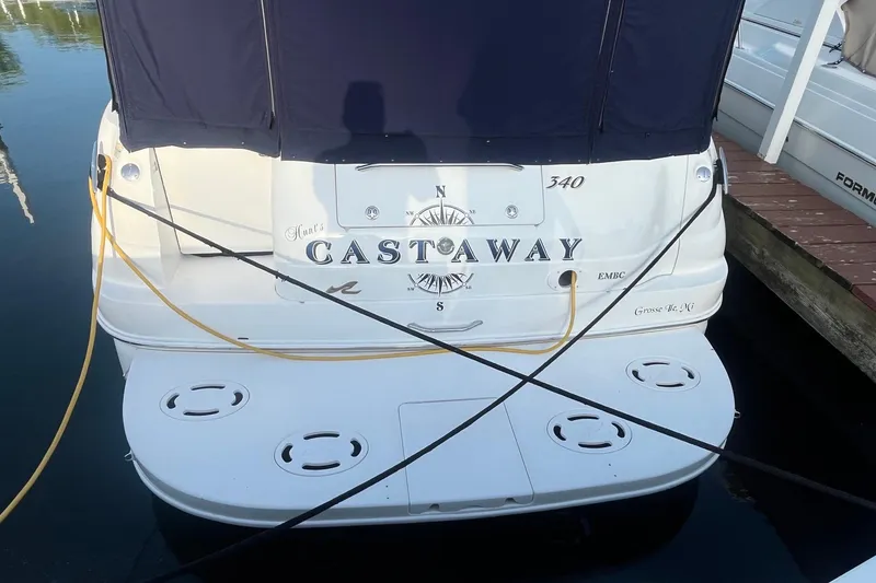 Slide: The Image of 2001 Sea Ray 340 Sundancer boat named "Castaway" docked at marina. - 3