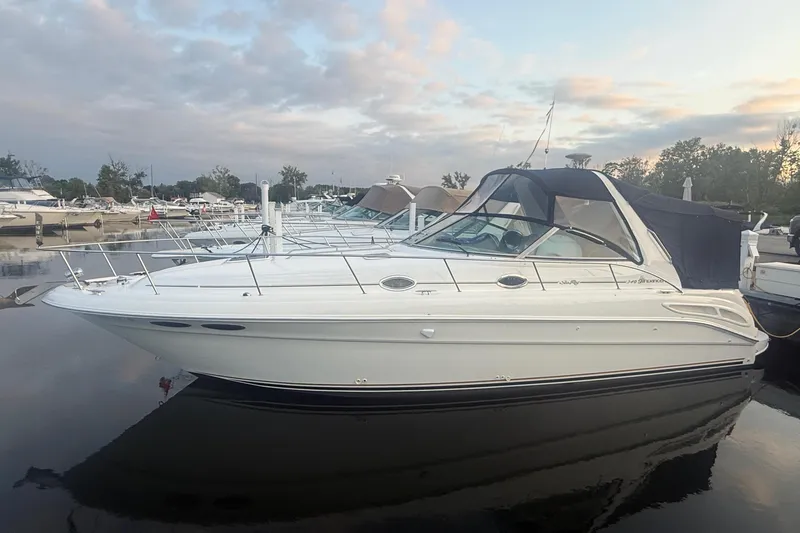 Slide: The Image of 2001 Sea Ray 340 Sundancer yacht docked at marina under cloudy sky. - 1