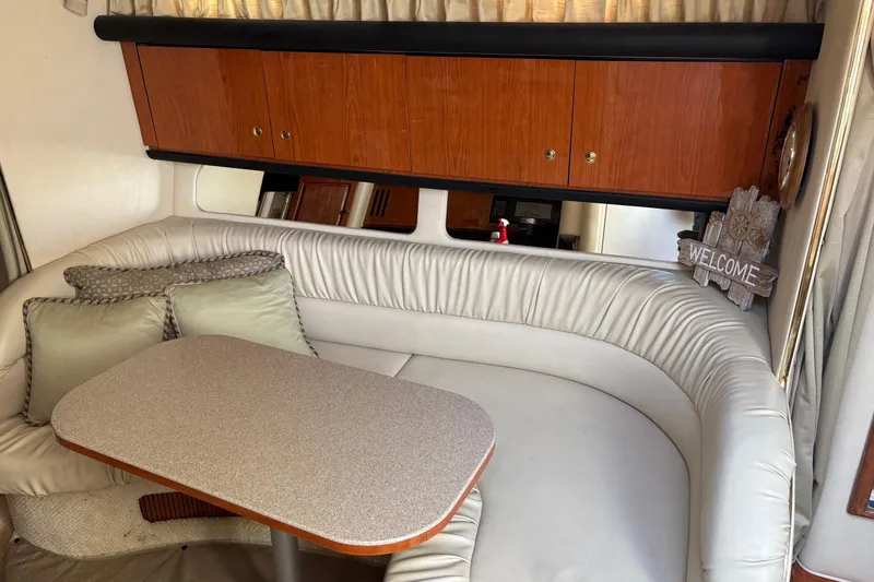 Slide: The Image of Interior of 2001 Sea Ray 340 Sundancer with cozy seating and wooden cabinets. - 21