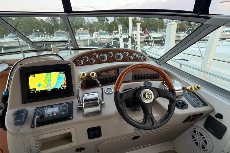 Slide: The Image of Helm of 2001 Sea Ray 340 Sundancer with navigation system and steering wheel. - 18