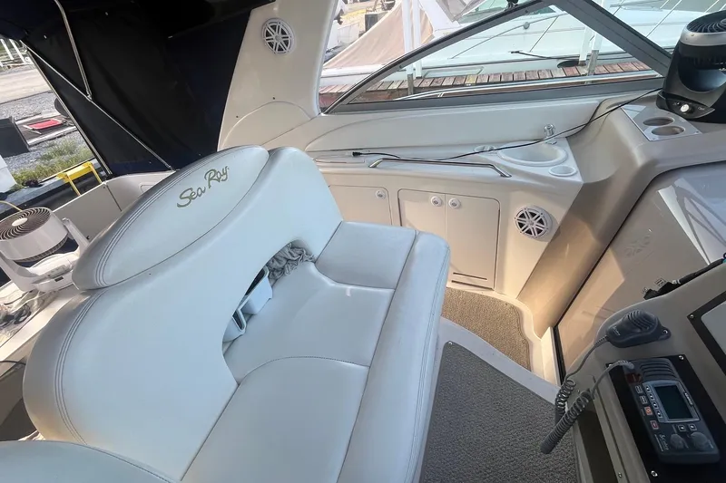 Slide: The Image of Interior of 2001 Sea Ray 340 Sundancer boat with white seating and control panel. - 9