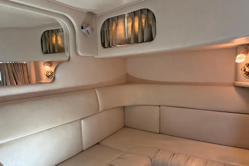 Slide: The Image of Interior of 2001 Sea Ray 340 Sundancer yacht with beige seating and ambient lighting. - 24