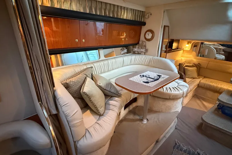 Slide: The Image of Luxurious interior of a 2001 Sea Ray 340 Sundancer yacht with plush seating and elegant decor. - 27