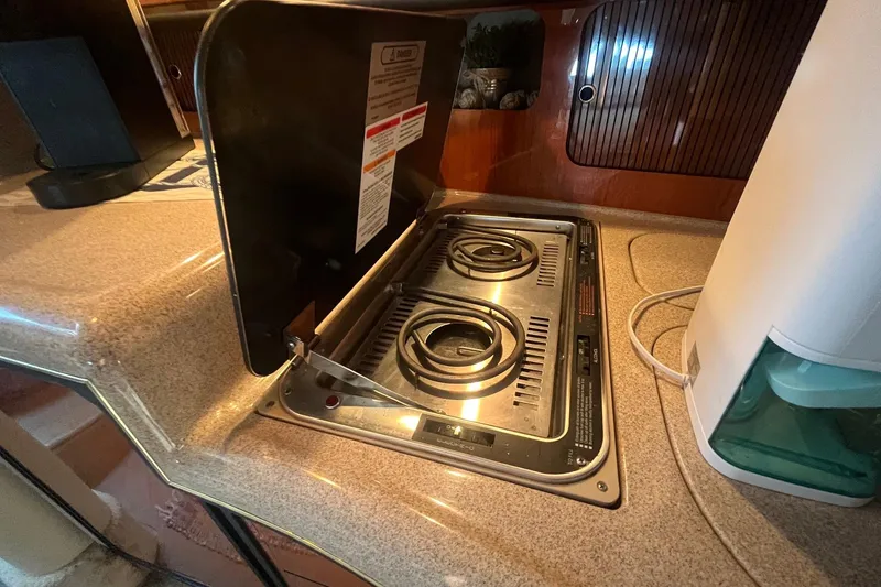 Slide: The Image of 2001 Sea Ray 340 Sundancer kitchen with electric stove and countertop. - 30