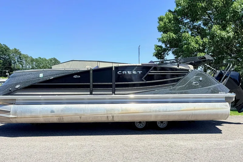 The Image of 2020 Crest Savannah 250 SLS pontoon boat parked outdoors on a sunny day. - 1