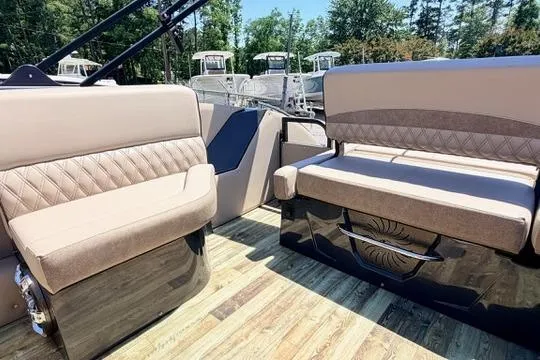 Slide: The Image of 2020 Crest Savannah 250 SLS boat interior with beige seating and wood flooring. - 12
