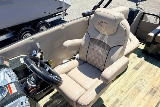 Slide: The Image of Captain's seat of 2020 Crest Savannah 250 SLS boat, featuring luxurious beige upholstery. - 17