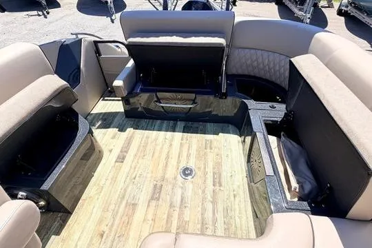 Slide: The Image of 2020 Crest Savannah 250 SLS boat interior with open storage compartments and wood-style flooring. - 19