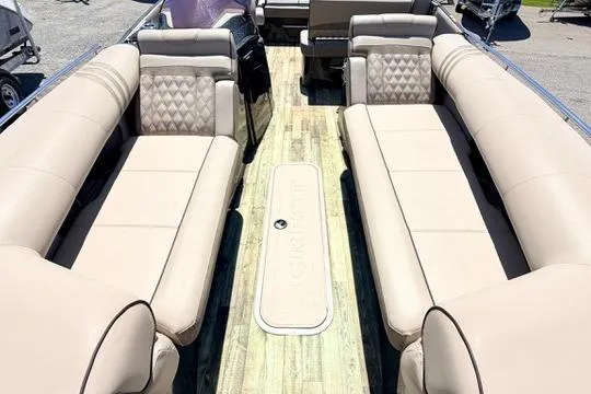 Slide: The Image of 2020 Crest Savannah 250 SLS pontoon boat with beige seating and wood-style flooring. - 20