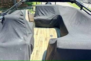 Slide: The Image of 2020 Crest Savannah 250 SLS boat interior with covered seating and wooden flooring. - 23