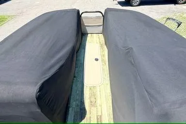 Slide: The Image of 2020 Crest Savannah 250 SLS boat with protective covers, parked outdoors. - 24