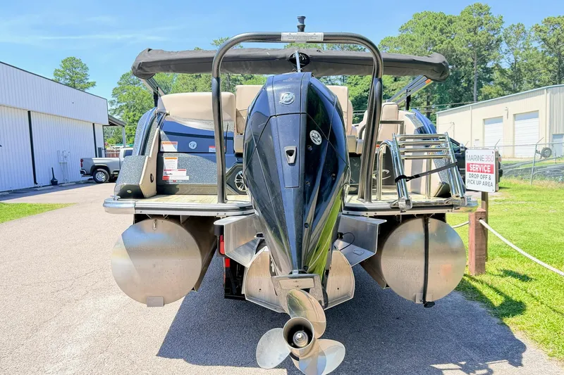 Slide: The Image of 2020 Crest Savannah 250 SLS pontoon boat with powerful outboard motor, parked outdoors. - 3
