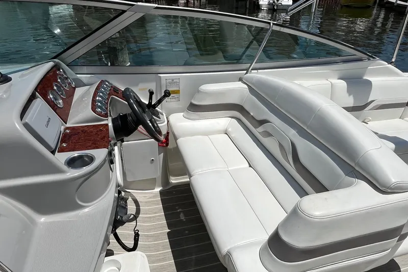Slide: The Image of 2002 Formula 330 Sun Sport boat interior with white seating and control panel. - 11