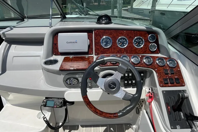 Slide: The Image of Cockpit of 2002 Formula 330 Sun Sport with Garmin navigation and woodgrain dashboard. - 13