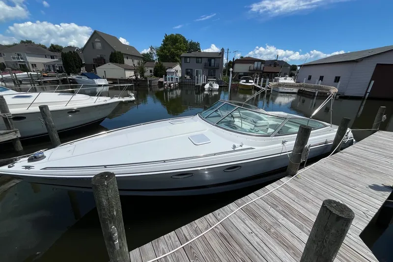 Slide: The Image of 2002 Formula 330 Sun Sport boat docked in a marina under a clear blue sky. - 2
