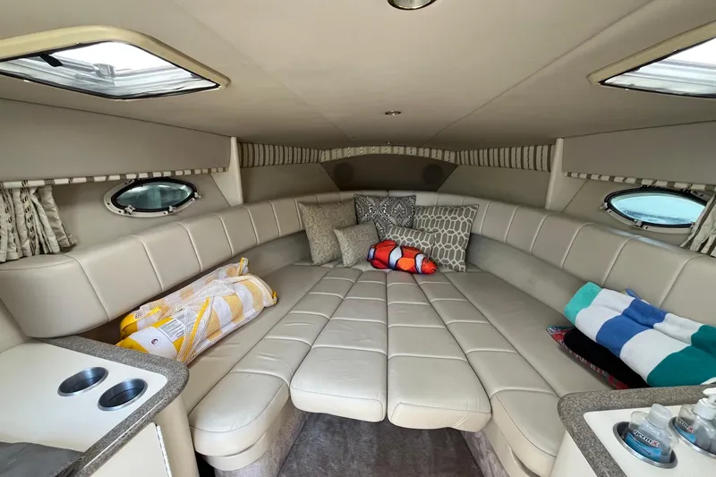 Slide: The Image of Luxurious interior of a 2002 Formula 330 Sun Sport boat with plush seating and portholes. - 20