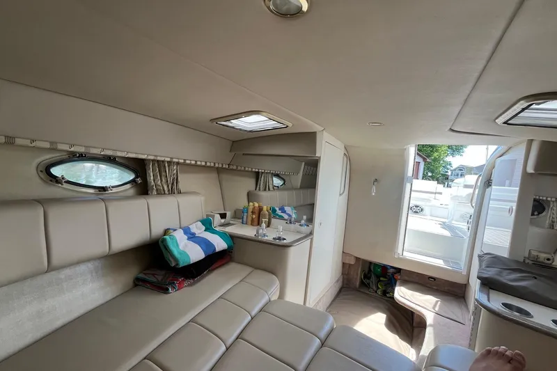 Slide: The Image of Interior of a 2002 Formula 330 Sun Sport boat with beige seating and open cabin door. - 21