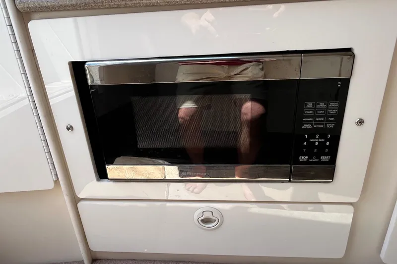 Slide: The Image of Built-in microwave on a 2002 Formula 330 Sun Sport boat interior. - 24