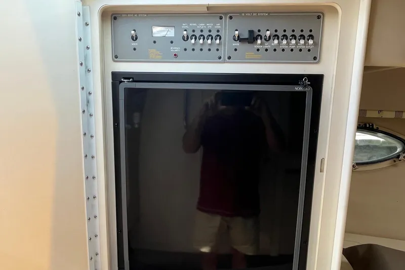 Slide: The Image of Control panel and refrigerator inside a 2002 Formula 330 Sun Sport boat. - 26