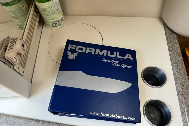 Slide: The Image of Binder for 2002 Formula 330 Sun Sport boat on countertop. - 28