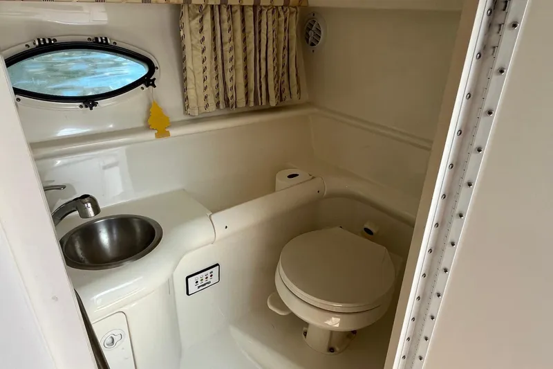 Slide: The Image of 2002 Formula 330 Sun Sport boat bathroom with sink, toilet, and window. - 29