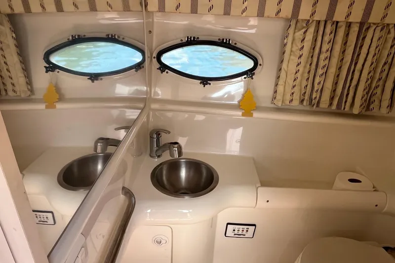 Slide: The Image of Interior of 2002 Formula 330 Sun Sport boat bathroom with sink and porthole windows. - 30
