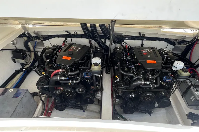 Slide: The Image of Twin engines in a 2002 Formula 330 Sun Sport boat, showcasing detailed mechanical components. - 31