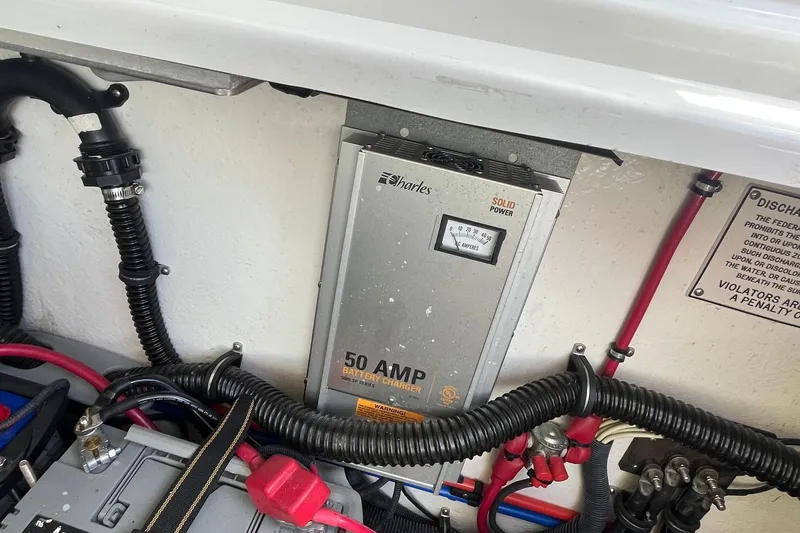 Slide: The Image of Battery charger setup in a 2002 Formula 330 Sun Sport boat engine compartment. - 33