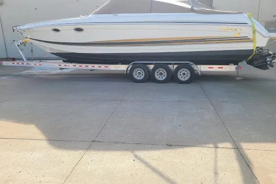 Slide: The Image of 2002 Formula 330 Sun Sport boat on a trailer, side view, outdoors. - 36