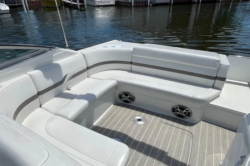 Slide: The Image of 2002 Formula 330 Sun Sport boat interior with white seating and wood-patterned flooring. - 5